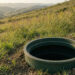 Open septic tank riser on a dry San Diego County hillside after access for solids measurement — Solid State Septic