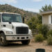 Septic pumper truck beside open green risers at a San Diego County home during professional cleaning — Solid State Septic
