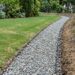 Grassy residential drainage corridor with stormwater channeling away from landscaped yard — Solid State Septic