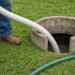 Septic service truck and technician at a residential property
