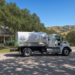 Septic pumping truck parked outside a California home
